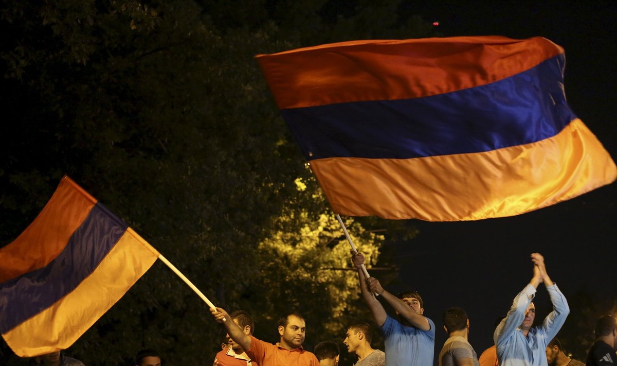 Protesters wave Armenian national flags during rally against hike in electricity prices in Yerevan