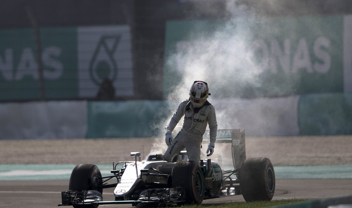 Pettunud Lewis Hamilton astub suitsevast autost välja.