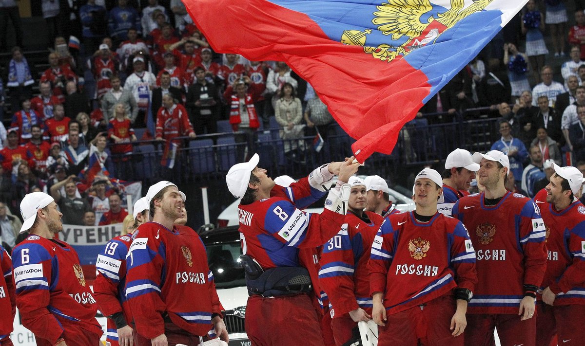 Russia's Ovechkin holds a national flag as he celebrates with his teammates winning their 2012 IIHF men's ice hockey World Championship final game against Slovakia in Helsinki