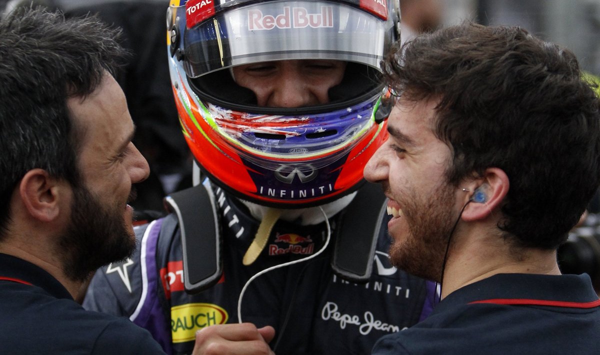 Red Bull Formula One driver Ricciardo of Australia celebrates finishing second fastest with teammates after the qualifying session for the Australian F1 Grand Prix in Melbourne