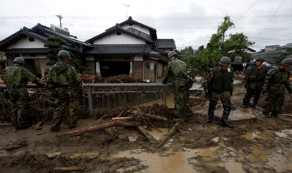 Japanese Self-Defense Force soldiers conduct search and rescue operation near houses damaged by a heavy rain in Asakura
