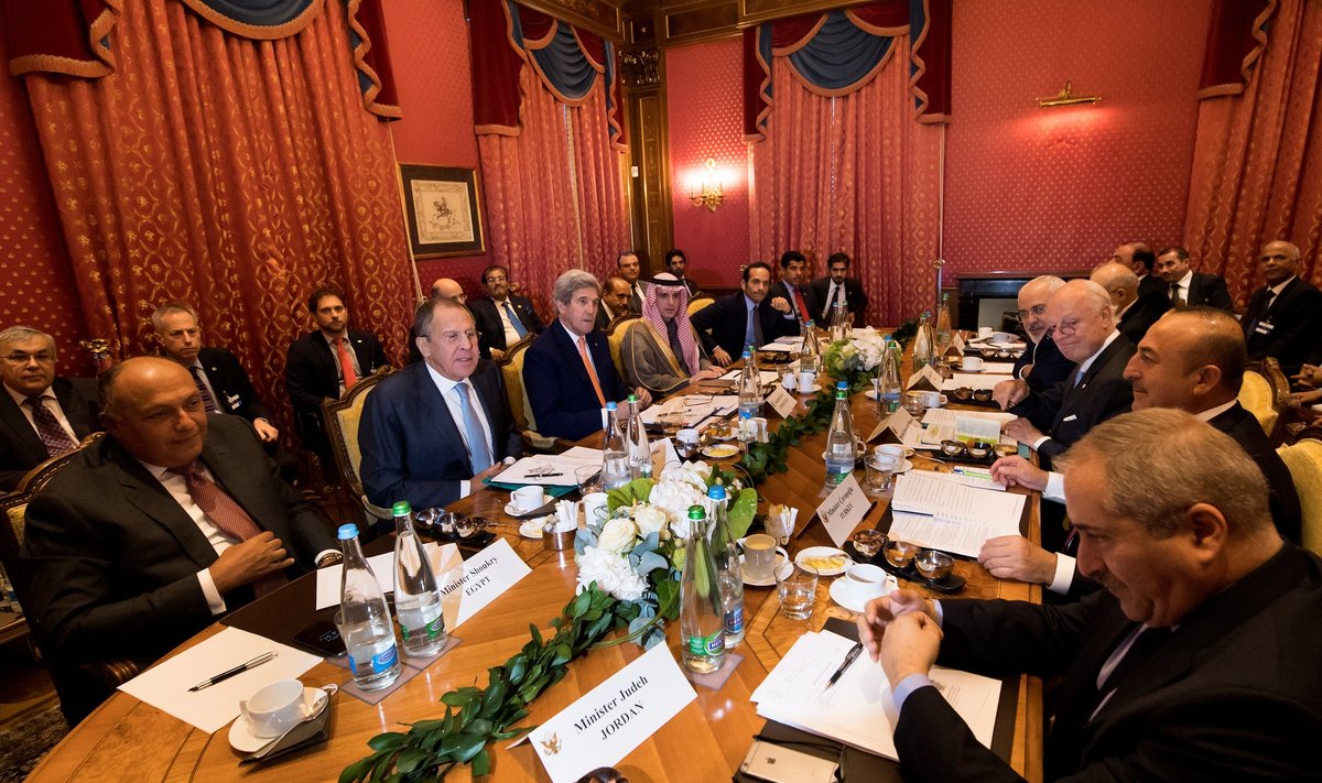 Foreign ministers meet around a table during a bilateral meeting where they discussed the crisis in Syria, in Lausanne