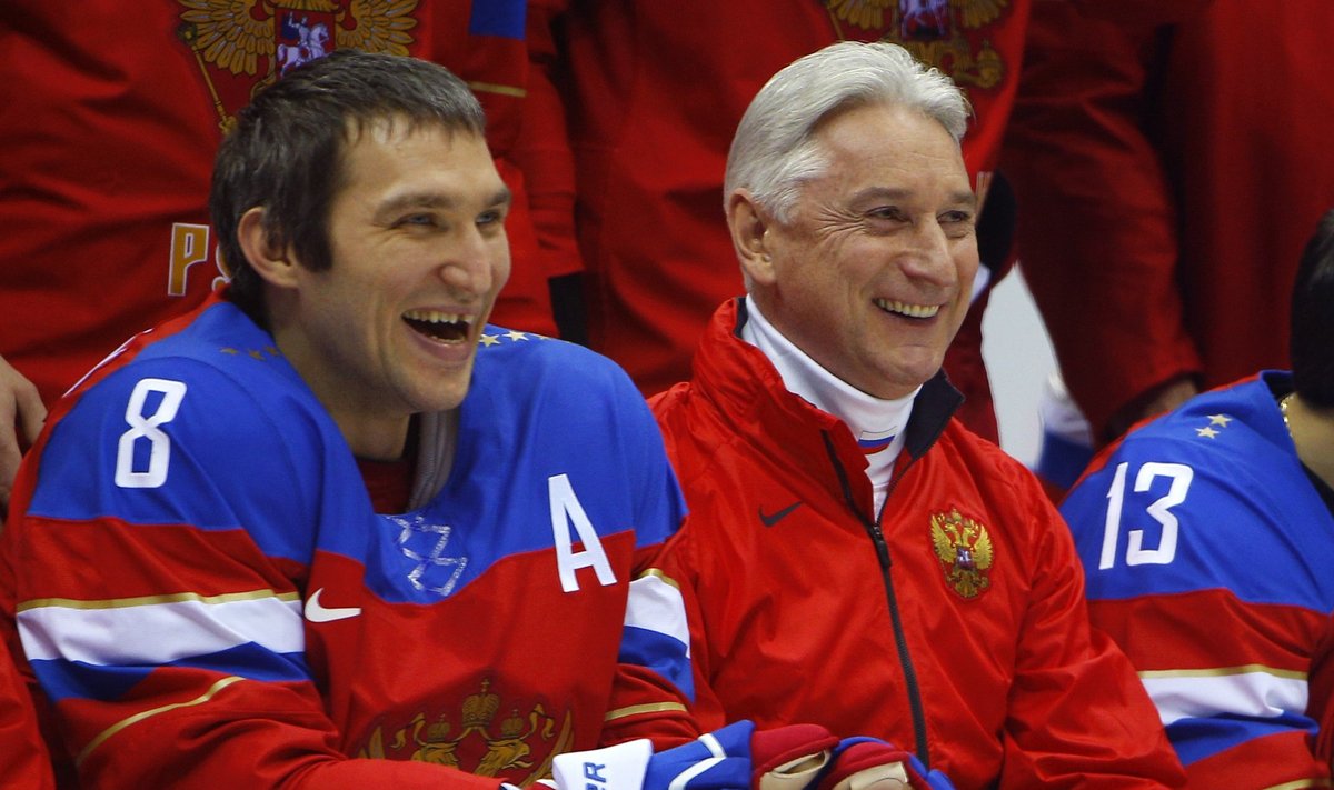 Russia's Alexander Ovechkin and head coach Zinetula Bilyaletdino laugh during practice at the 2014 Sochi Winter Olympics