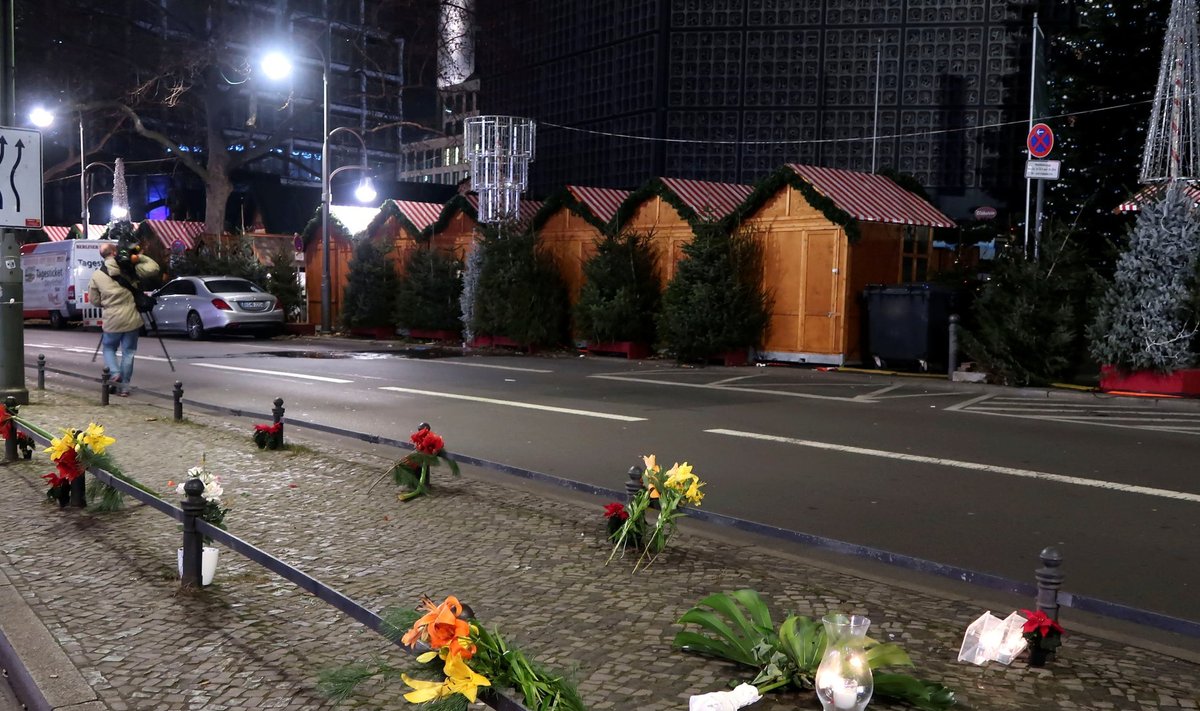 Candles and flowers are seen near the site where a truck ploughed through a crowd at a Berlin Christmas market