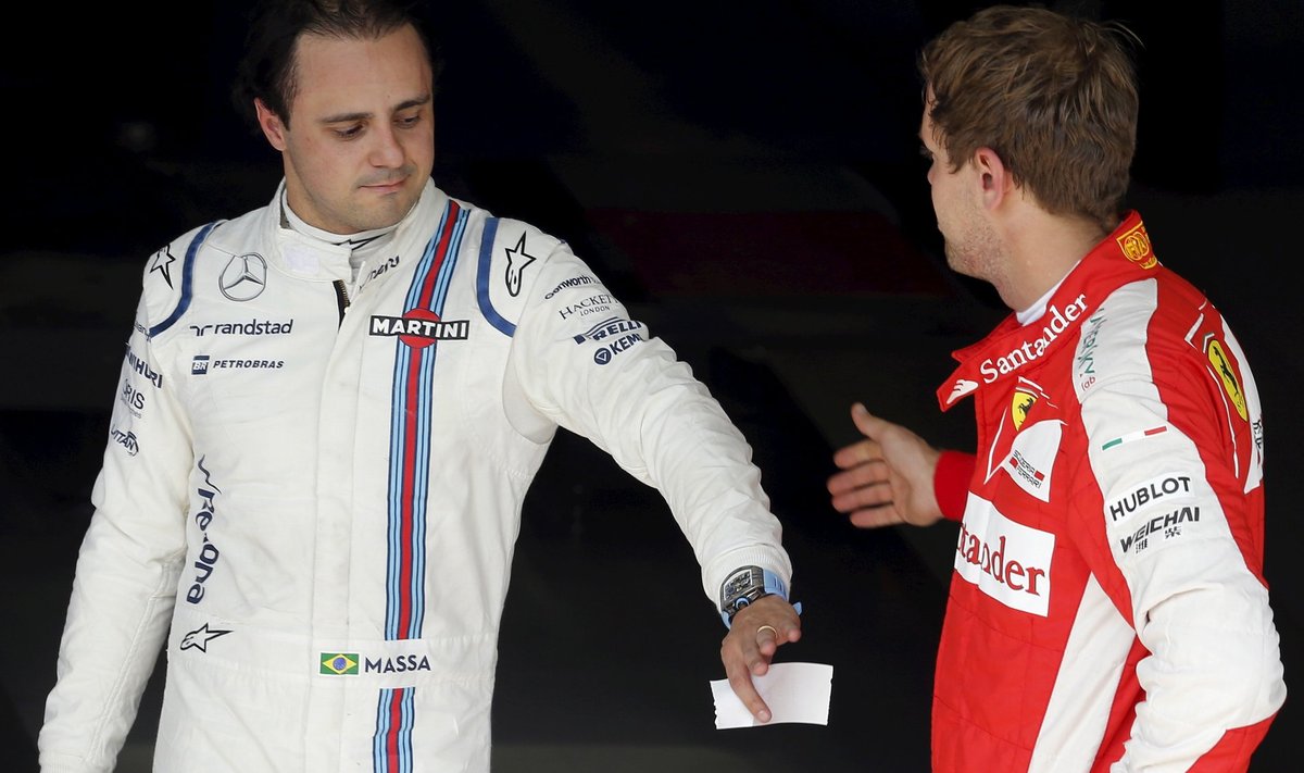 Williams Formula One driver Massa of Brazil congratulates Ferrari Formula One driver Vettel of Germany after their qualifying session of the Brazilian F1 Grand Prix in Sao Paulo