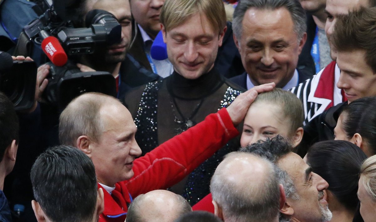 Yulia Lipnitskaya and Evgeny Plyushchenko with Russia's figure skating team is greeted Russia's President Vladimir Putin at the Sochi 2014 Winter Olympics