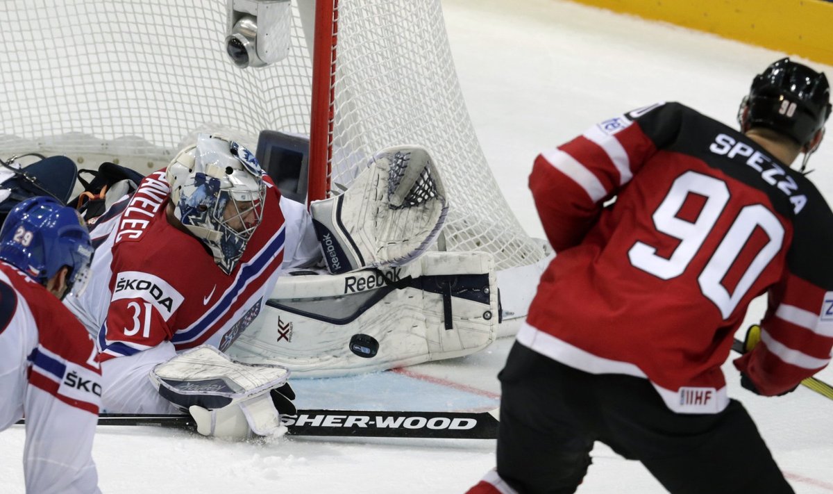 Goaltender Pavelec of the Czech Republic saves a shot of Canada's Spezza during their Ice Hockey World Championship game at the O2 arena in Prague