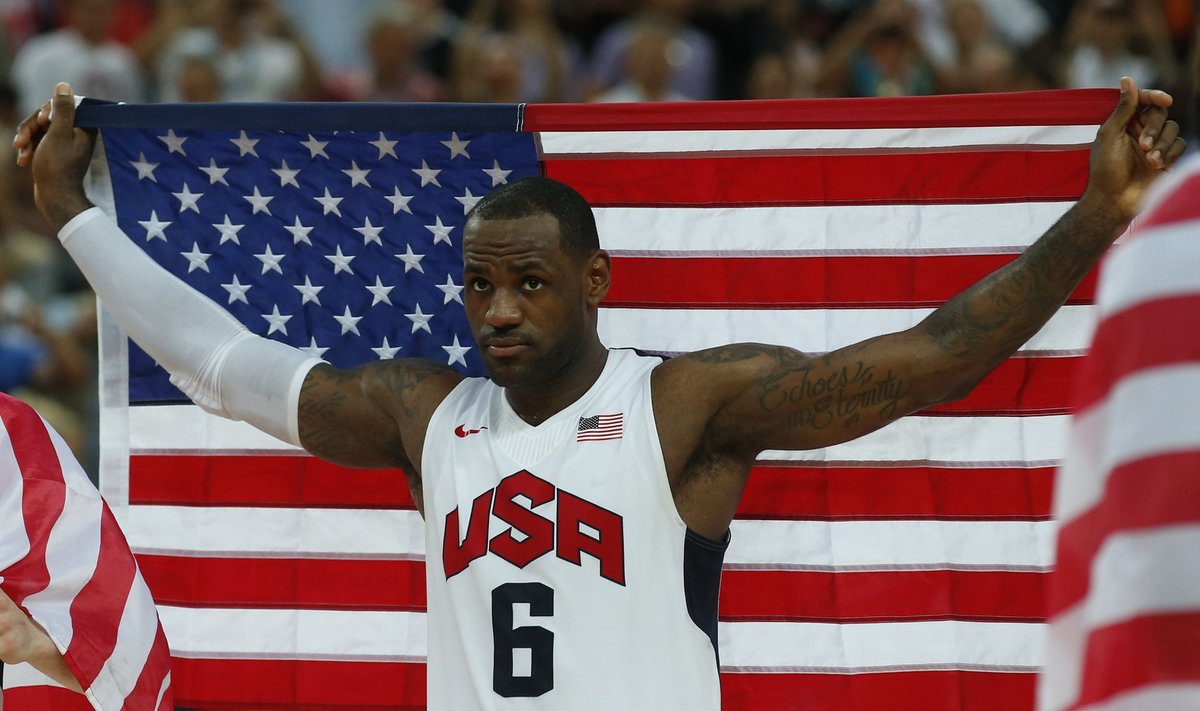 James of the U.S. celebrates with national flag victory against Spain after their men's gold medal  basketball match at the North Greenwich Arena in London during the London 2012 Olympic Games