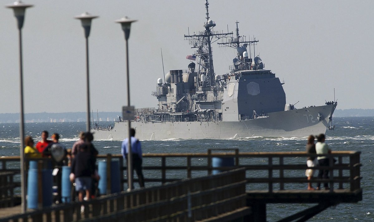 Tourists watch the USS Mahan, an Arleigh Burke class destroyer, as it heads out to the Atlantic Ocean through the Chesapeake Bay-Bridge Tunnel complex near Virginia Beach in this file photo