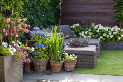 Modern,Lounge,Sofa,In,The,Garden,With,Blooming,Flowers,,Outdoor