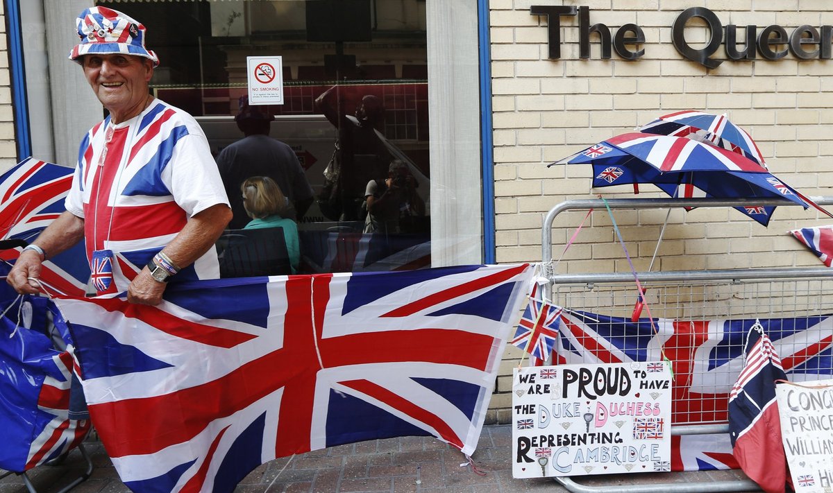 A royal supporter adjusts Union flags outside the Lindo Wing of St Mary's Hospital, where Britain's Catherine, Duchess of Cambridge is due to give birth, in London