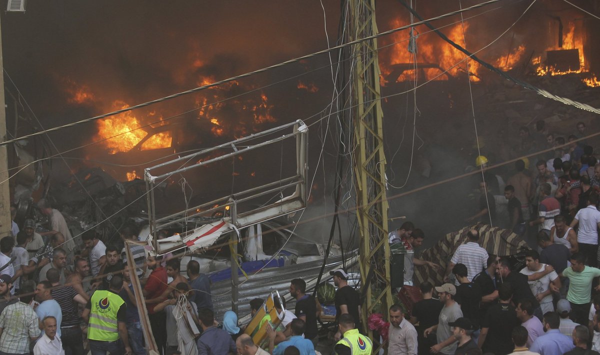 Cars burn at the site of an explosion in Beirut's southern suburbs