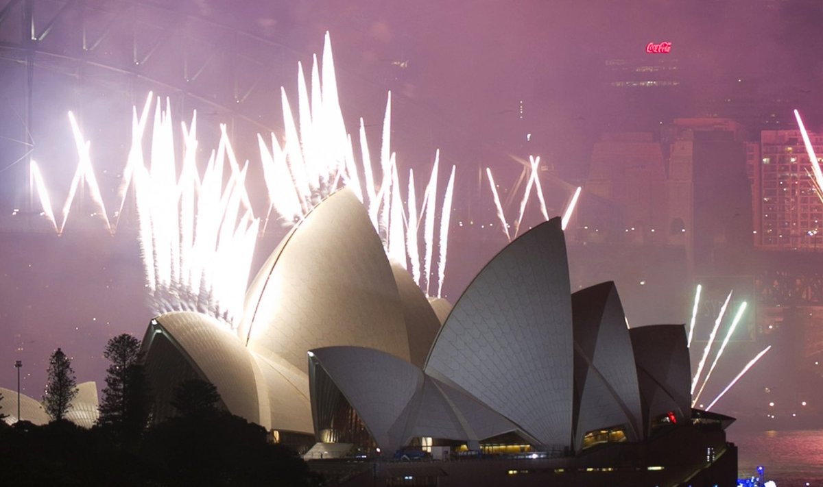 Fireworks explode off the Sydney Opera House at midnight, ushering in the new year, in Sydney