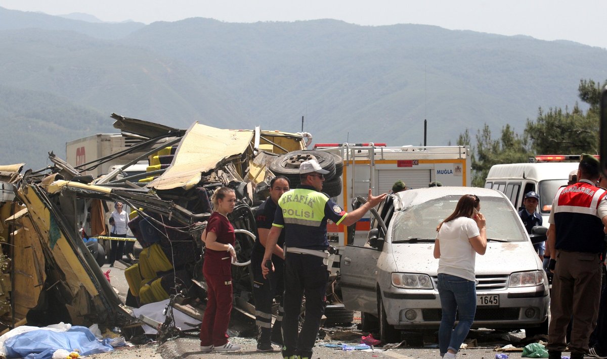 Medics and rescue workers stand at the scene after a tourist bus crashed near the southwestern holiday town of Marmaris