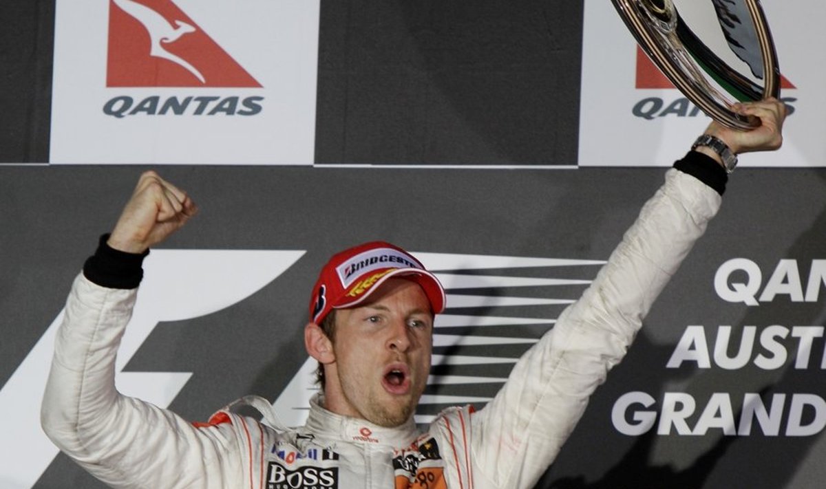 McLaren Formula One driver Jenson Button of Britain  holds his trophy aloft as he celebrates on the podium after winning the Australian Formula One Grand Prix in Melbourne,Sunday, March 28, 2010. (AP Photo/Mark Baker) / SCANPIX Code: 436