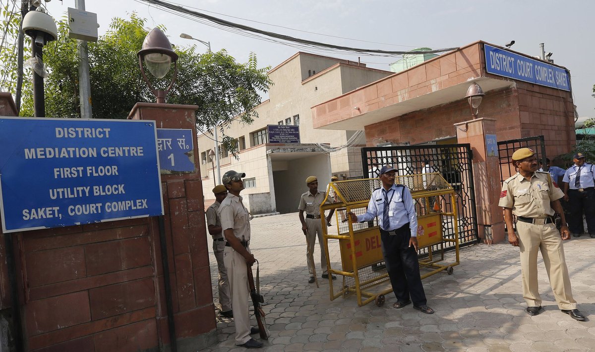 Policemen stand guard outside a court in New Delhi