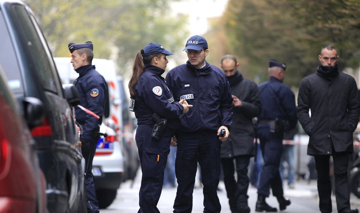 French police officers cordon the area next to newspaper Liberation's headquarters in Paris