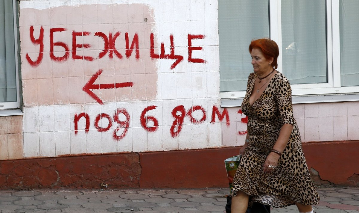 Woman walks in the southern coastal town of Mariupol