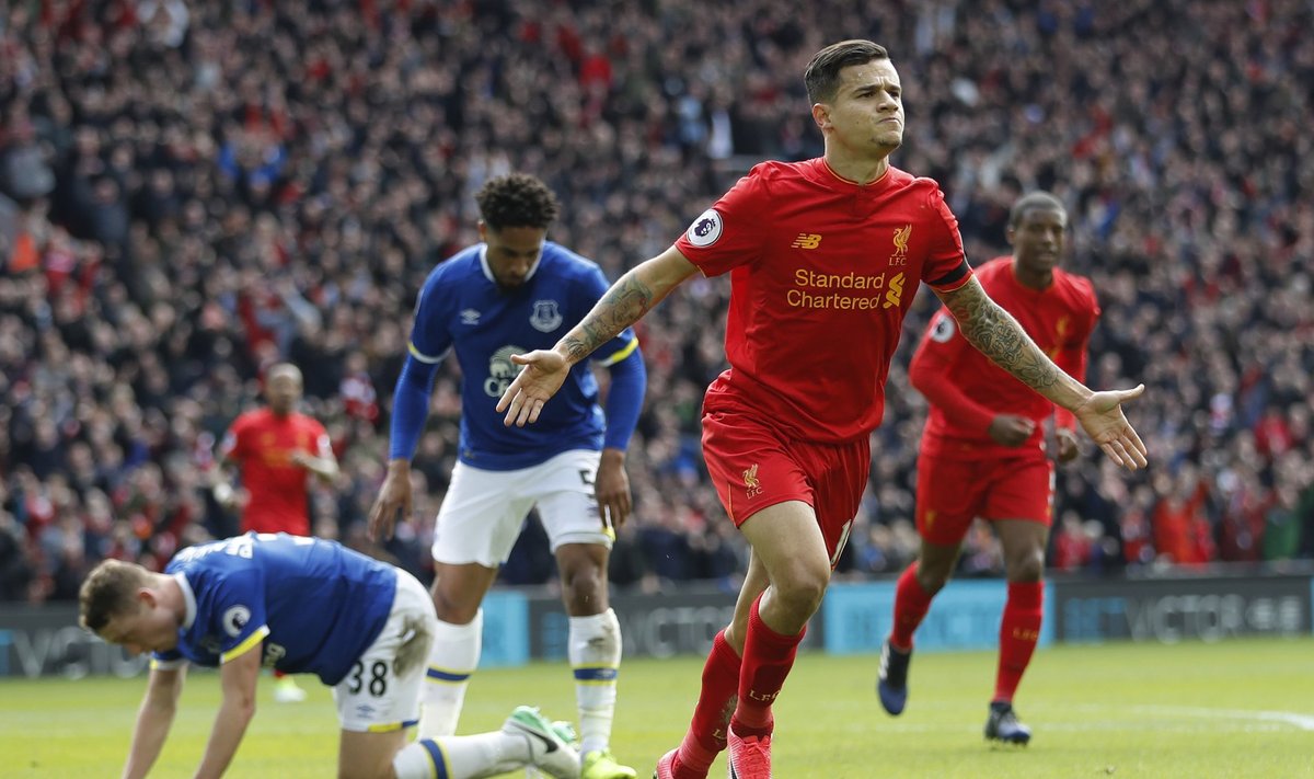 Liverpool's Philippe Coutinho celebrates scoring their second goal as Everton's Matthew Pennington (L) looks dejected