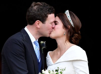 Britain's Princess Eugenie and Jack Brooksbank kiss as they leave after their wedding at St George's Chapel in Windsor Castle, Windsor