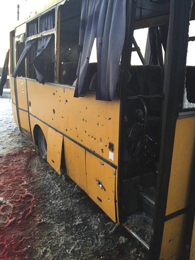 A passenger bus damaged by recent shelling at a checkpoint of the Ukrainian forces in the village of Bugas, south of Donetsk