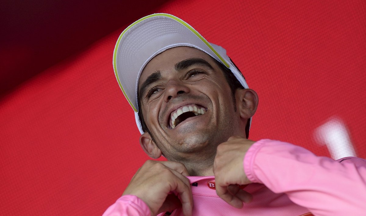 Tinkoff-Saxo rider Alberto Contador of Spain celebrates on the podium as he wears the leader's pink jersey after  the 236 km 19th stage of the 98th Giro d'Italia cycling race from Gravellona Toce to Cervinia