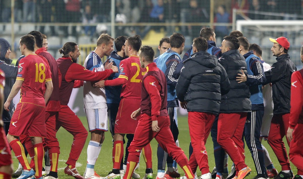 Russia's players scuffle with Montenegro's players during their Euro 2016 Group G qualifying soccer match in Podgorica