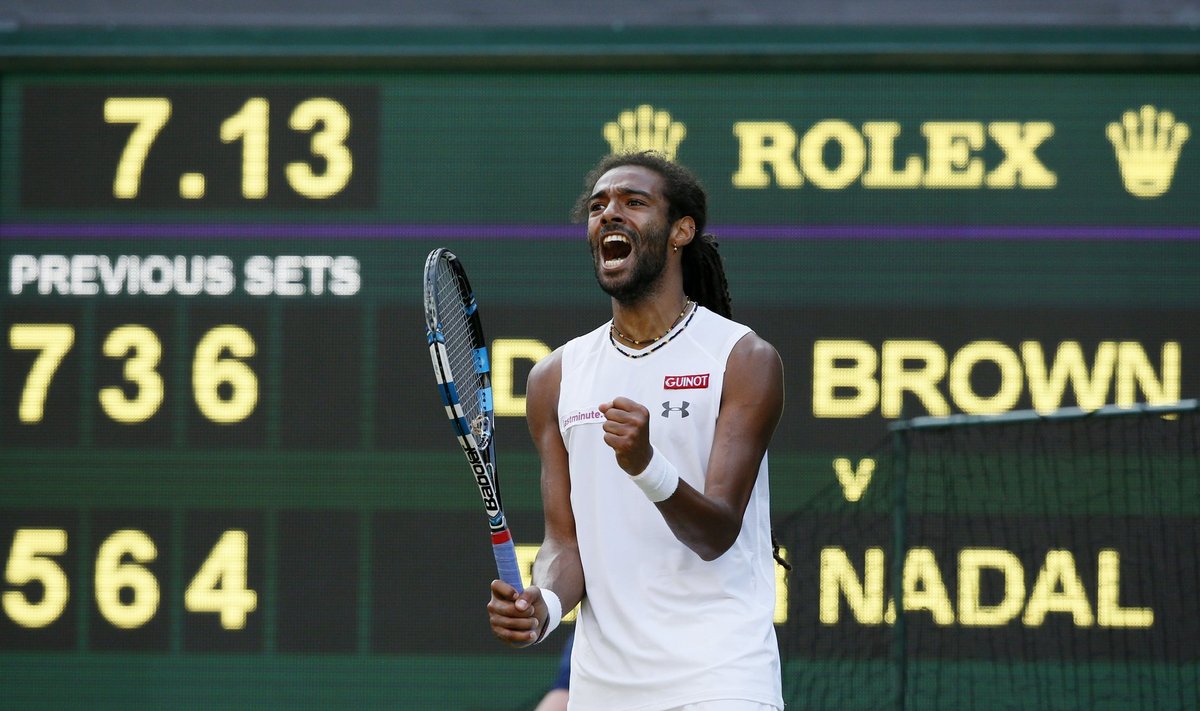 Dustin Brown of Germany celebrates after breaking serve in fourth set during his match against Rafael Nadal of Spain at the Wimbledon Tennis Championships in London