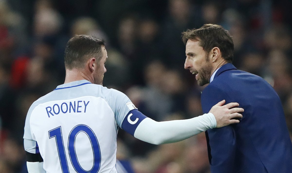 England interim manager Gareth Southgate speaks with Wayne Rooney