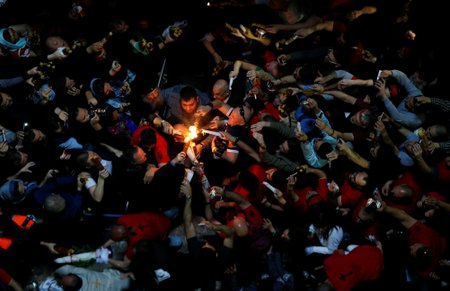 Worshippers take part in the Christian Orthodox Holy Fire ceremony at the Church of the Holy Sepulchre in Jerusalem's Old City