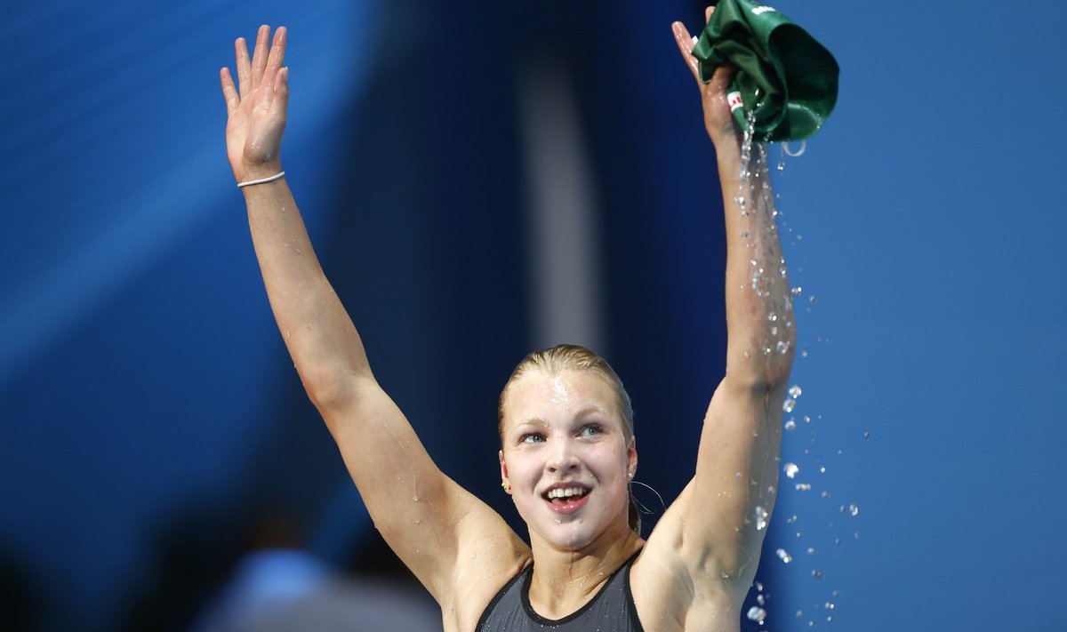 Lithuania's Meilutyte smiles after winning the women's 50m breaststroke semi-final during the World Swimming Championships in Barcelona