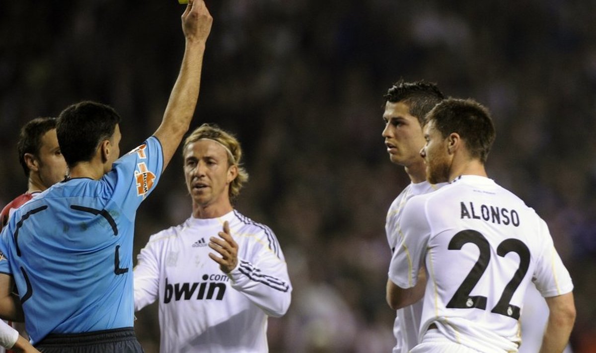Real Madrid's Jose Maria Gutierrez (C) and Xabi Alonso (L) protest as Cristiano Ronaldo receives a yellow card during their Spanish first division soccer league match against Athletic Bilbao at San Mames stadium in Bilbao, January 16, 2010. Athletic won 1-0REUTERS/Vincent West (SPAIN - Tags: SPORT SOCCER)