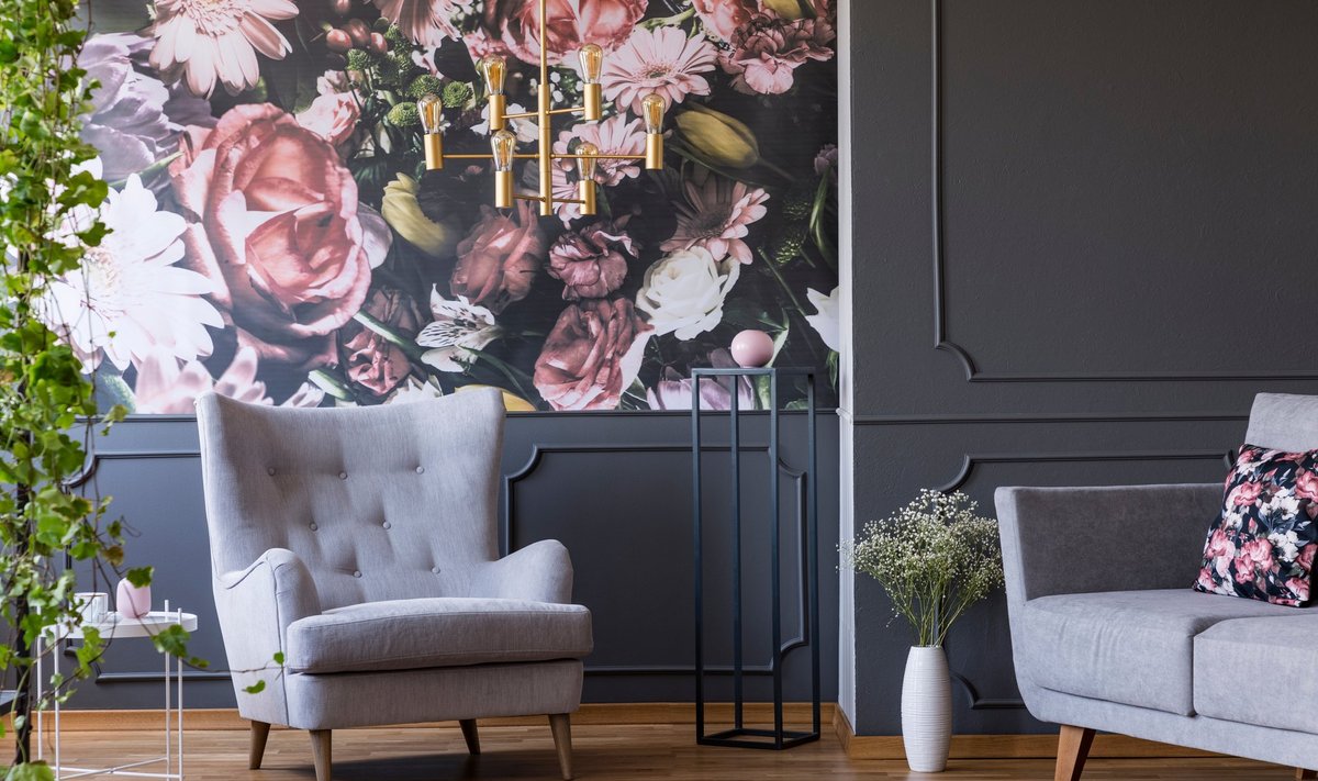Grey,Armchair,Against,Flowers,Wallpaper,In,Dark,Living,Room,Interior