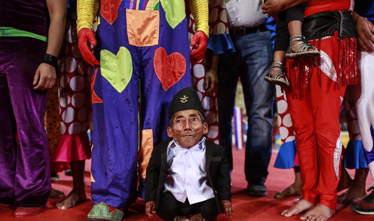 The world's shortest man Chandra Bahadur Dangi, 72, poses for a picture with the artists of the Rambo circus in Mumbai