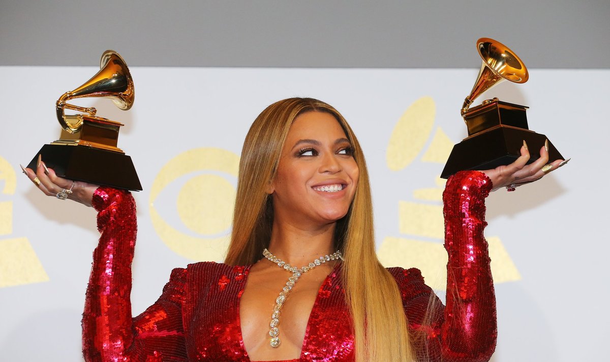 Beyonce holds the awards she won at the 59th Annual Grammy Awards in Los Angeles