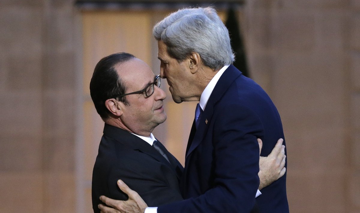 French President Hollande welcomes U.S. Secretary of State Kerry before their meeting at the Elysee Palace in Paris