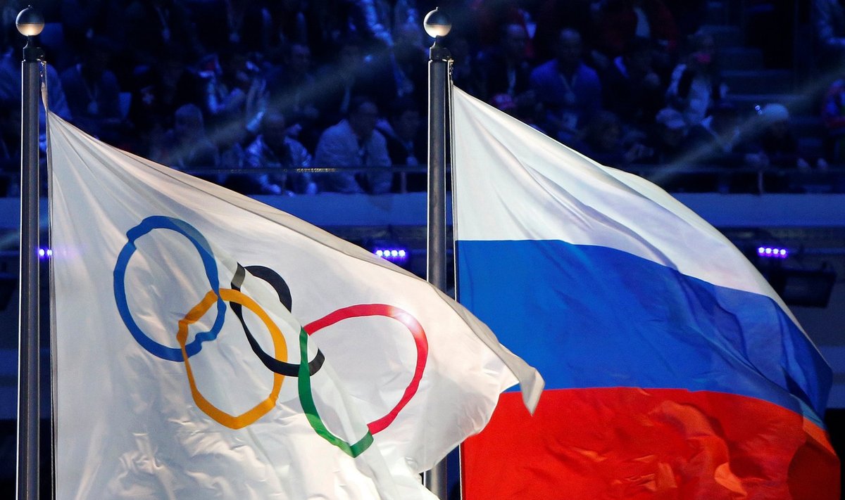Russian national flag and Olympic flag are seen during closing ceremony for 2014 Sochi Winter Olympics