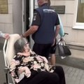 74-летнюю пенсионерку в инвалидном кресле несут на языковой экзамен. Видео набирает миллионы просмотров