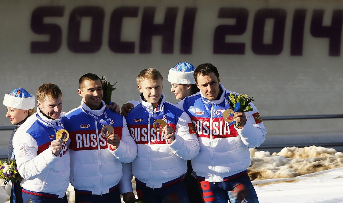 Zubkov, Negodaylo, Trunenkov and Voevoda celebrate during the medal ceremony for the four-man bobsleigh event of the Sochi 2014 Winter Olympic Games