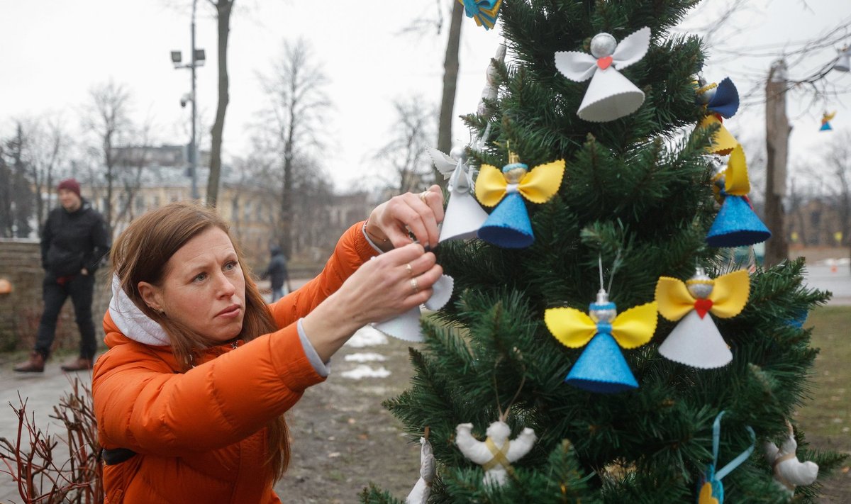 JÕULUPUU KIIEVIS: Tänane pilt, kus ukrainlanna ehib Iseseisvuse väljaku lähedal jõulupuud südamete ja inglitega sõjas langenud sangarite mälestuseks.