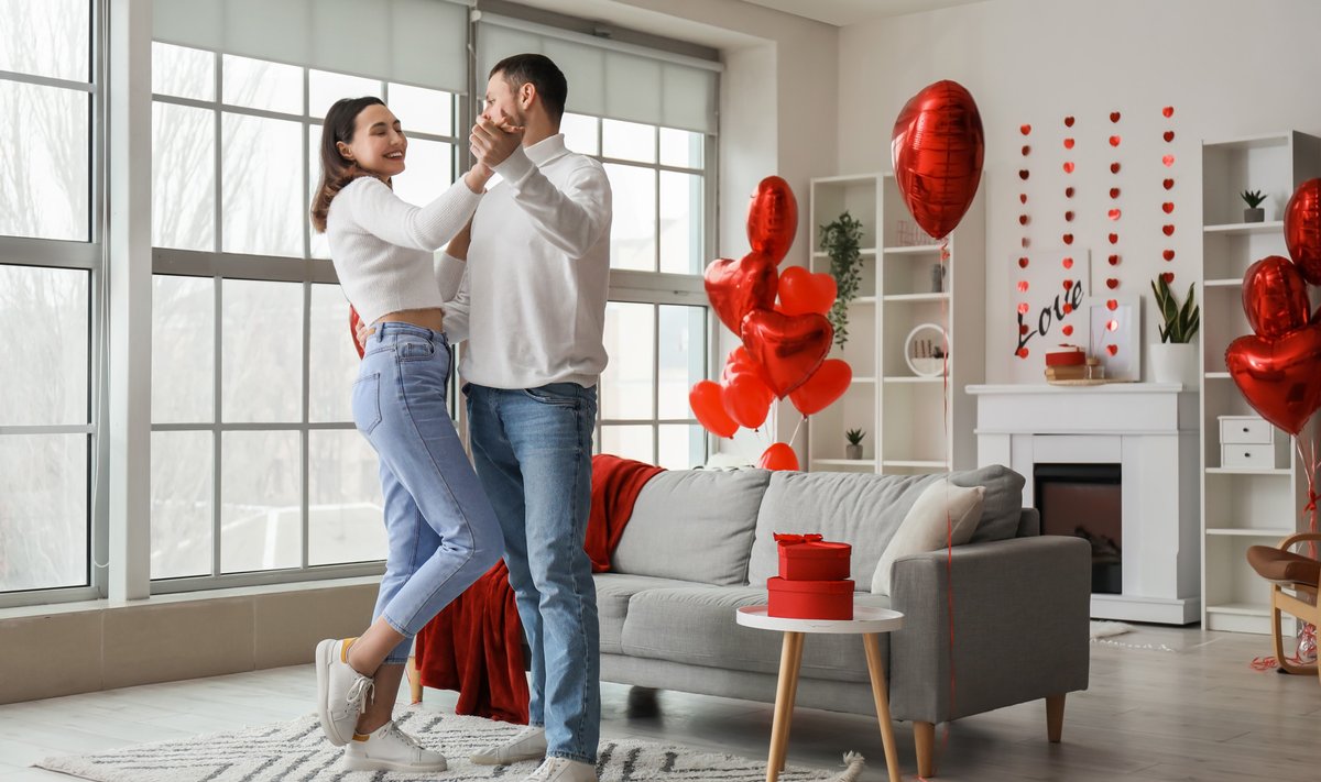 Happy couple in love dancing at home on Valentine's Day