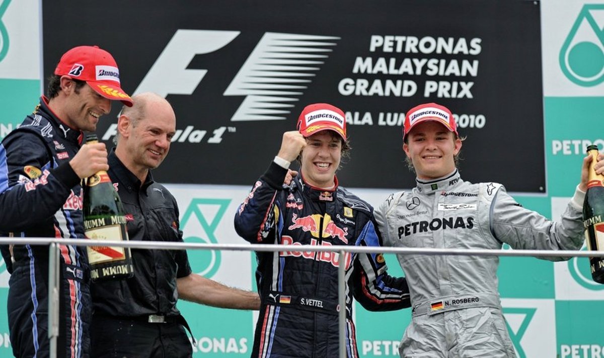 Red Bull-Renault driver Sebastian Vettel (2nd R) of Germany celebrates with teammate and second-placed Mark Webber (L) of Australia and third-placed Mercedes driver Nico Rosberg of Germany (R) on the podium after Formula One's Malaysian Grand Prix in Sepang on April 4, 2010. Vettel in a Red Bull won the Malaysian Grand Prix, leading from start to finish.   AFP PHOTO/ROSLAN RAHMAN