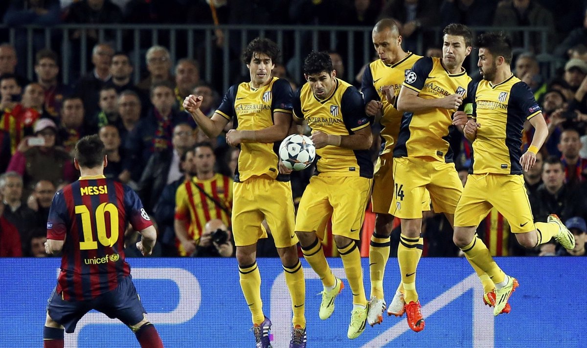 Barcelona's Messi shoots a free-kick over Atletico Madrid's Tiago, Costa, Miranda, Gabi and Villa during their Champions League quarter-final first leg soccer match in Barcelona