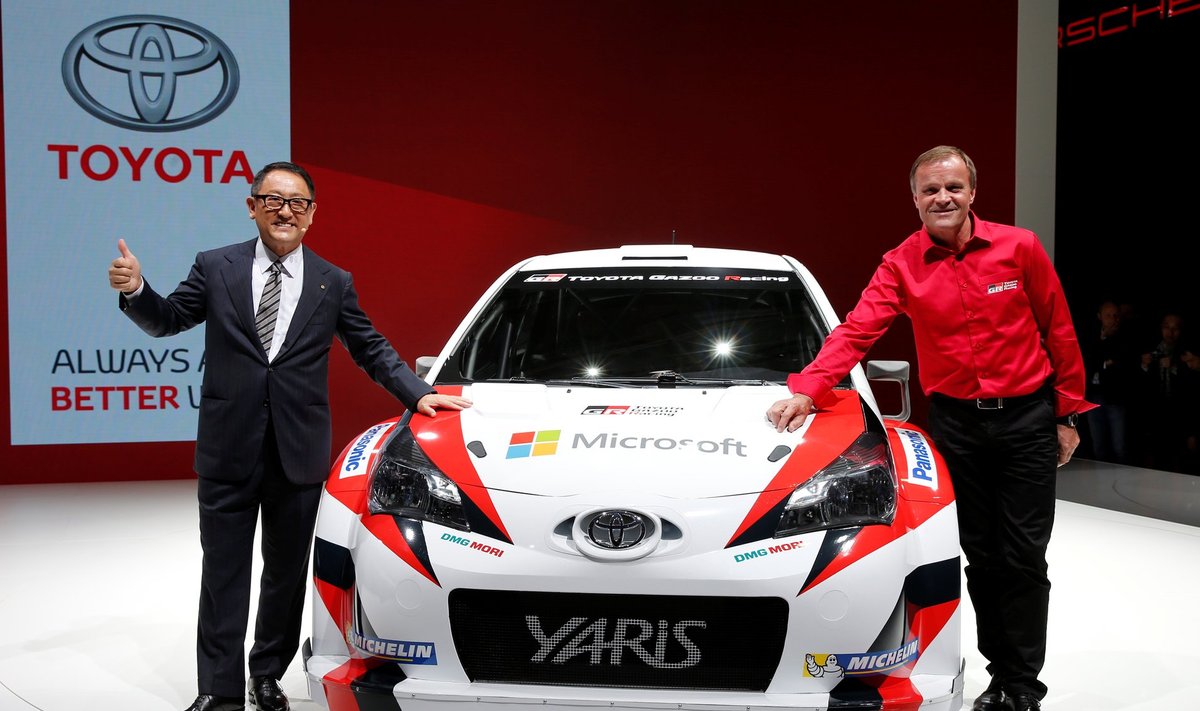 Akio Toyoda, President and CEO of Toyota Motor Corporation, and rally driver Tommi Makinen of Finland pose after a news conference on media day at the Paris auto show, in Paris