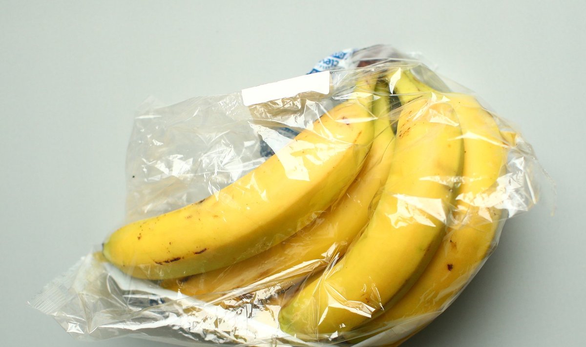 Bananas, wrapped in a plastic foil as bought in a supermarket, are seen in this picture illustration