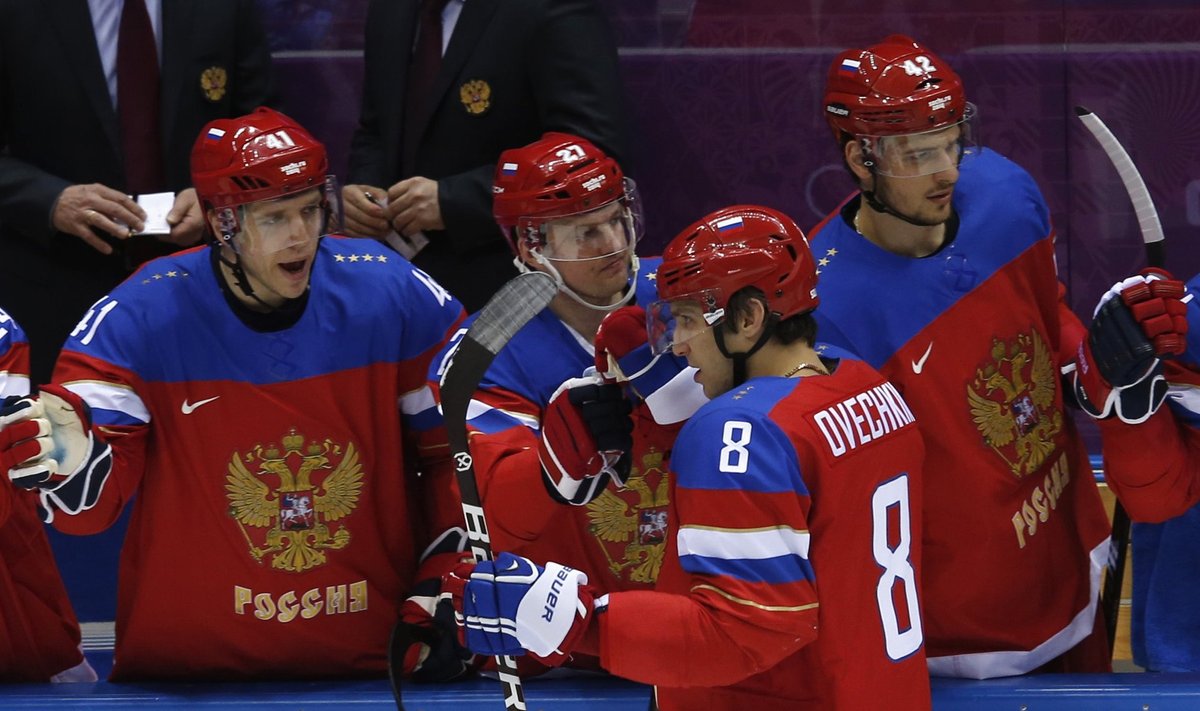 Russia's Ovechkin is congratulated by teammates after scoring a goal during their men's preliminary round ice hockey game against Slovenia at the Sochi 2014 Winter Olympic Games