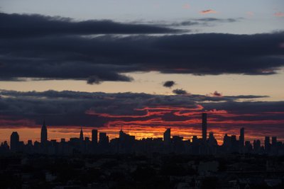 The Manhattan skyline is seen during sunset  from Arthur Ashe Stadium as Federer of Switzerland faces Djokovic of Serbia during their men's singles final match at the U.S. Open Championships tennis tournament in New York