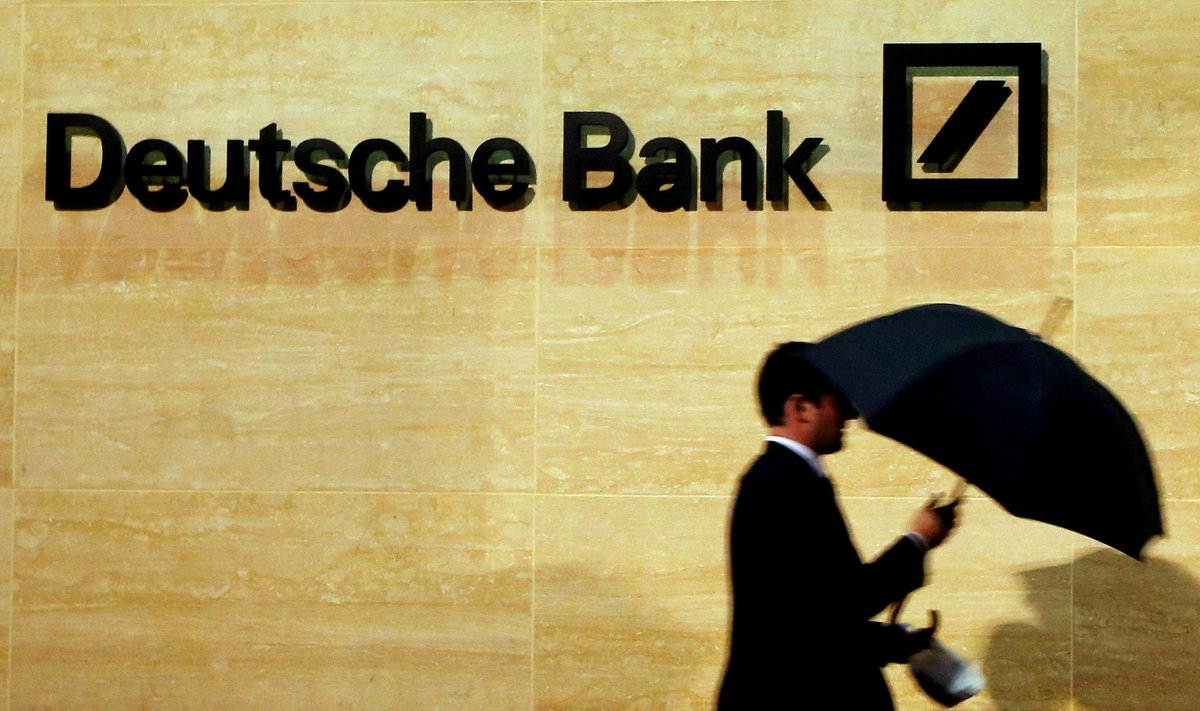 FILE PHOTO: A man walks past Deutsche Bank offices in London