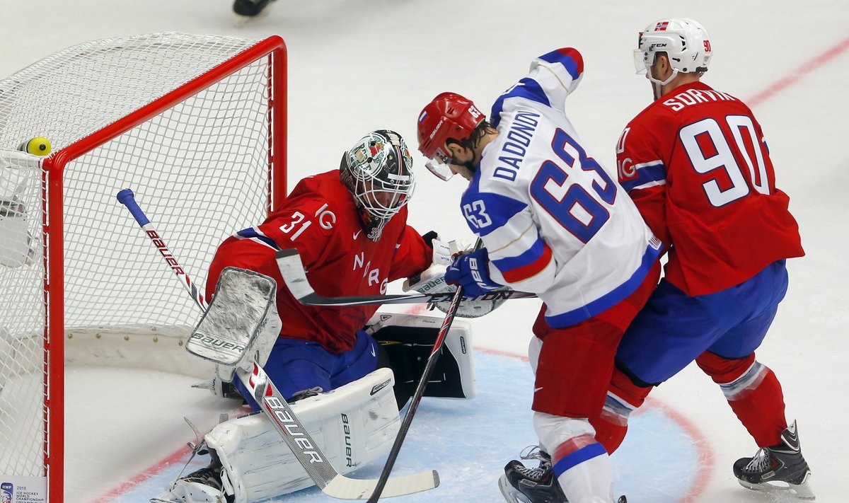 Norway's goalkeeper Volden eyes the puck next to Russia's Dadonov and Norway's Sorvik during their men's ice hockey World Championship game in Ostrava