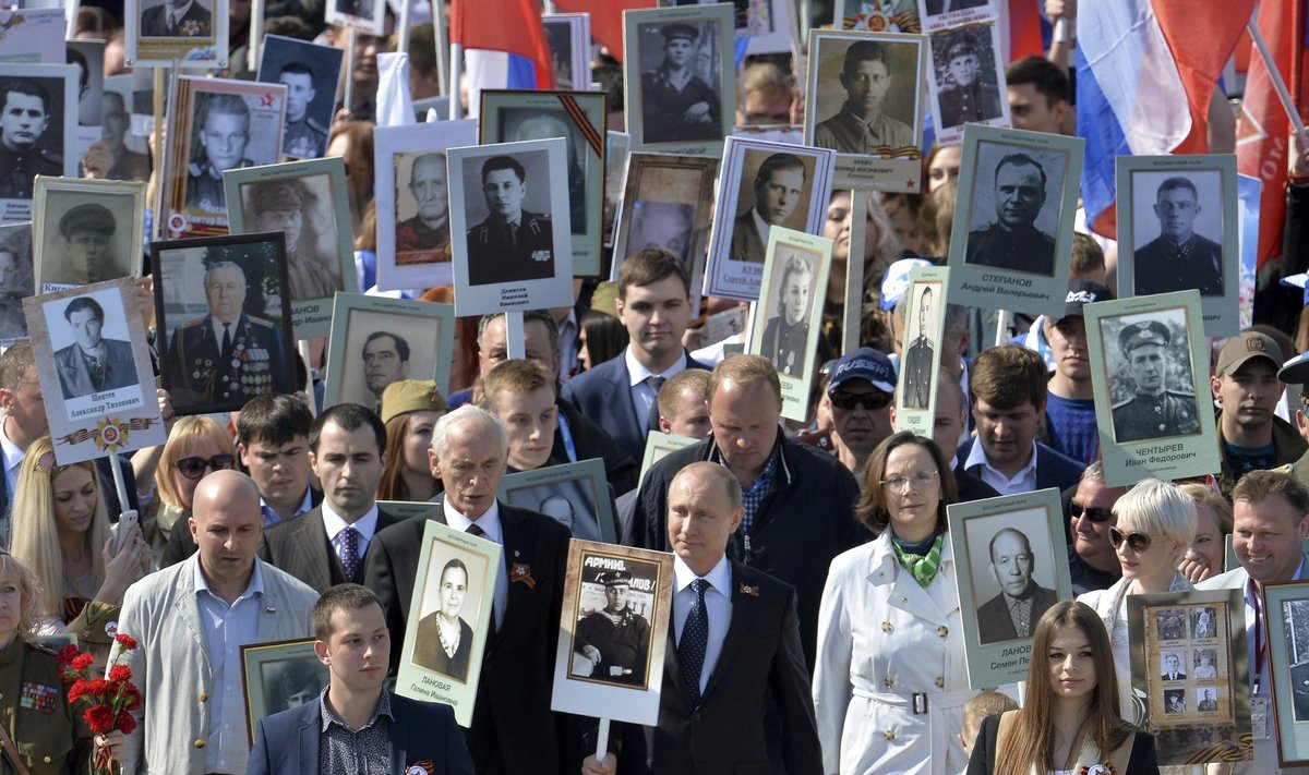 Russian President Putin holds the portrait of his father as he takes part in the Immortal Regiment march with pictures of World War Two soldiers on Red Square during the Victory Day celebrations in Moscow